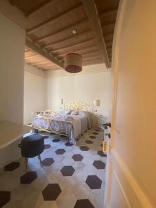 a bedroom with a bed and a checkered floor at punti di vista in Bibbona