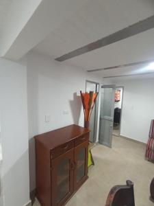 una habitación con un armario de madera con un jarrón. en Apartamento Central en Ibagué