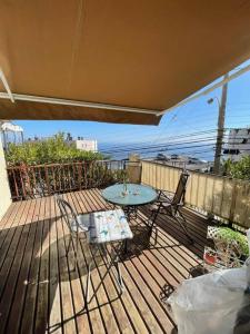 a patio with a table and chairs on a deck at Hermosa Casa Reñaca con Vista al Mar in Viña del Mar