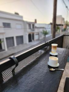 a cup of coffee and a spoon on a table at At Home CdelU in Concepción del Uruguay