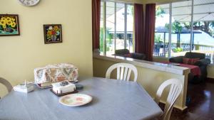 a dining room with a table with a bag on it at House of Erabo in Runaway Bay