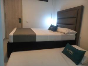 Postel nebo postele na pokoji v ubytování Hotel Colombia Avenida