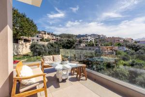 a balcony with a table and chairs and a view at Gk Halepa Luxury apartment in Chania Town