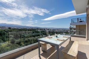 a dining table on the balcony of a house at Gk Halepa Luxury apartment in Chania Town