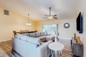 a living room with a couch and a table at Santiago Lane Retreat in Bonita Springs