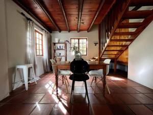 a dining room with a wooden table and chairs at Comfy Greyton Cottage for Four in Greyton
