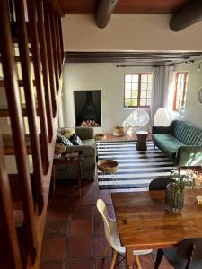 a living room with a couch and a table at Comfy Greyton Cottage for Four in Greyton