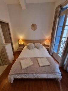 sypialnia z dużym łóżkiem i dwiema poduszkami w obiekcie Le Dalí-Duplex au pied de Castillet w Perpignanie