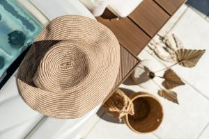 a straw hat sitting on the floor next to a pool at Crocus Apartments in Sirmione