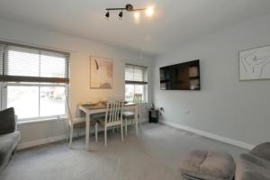 a living room with a table and chairs and a couch at Crewe Short Lets 2 Victoria Court, Crewe in Crewe