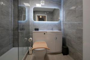 a bathroom with a toilet and a sink and a mirror at Crewe Short Lets 2 Victoria Court, Crewe in Crewe +9 photos