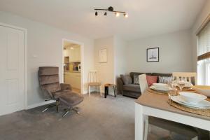 a living room with a table and a couch at Crewe Short Lets 2 Victoria Court, Crewe in Crewe