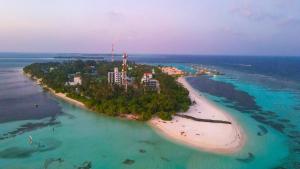 an island in the ocean next to a beach at Ari Grand Hotel & Spa in Dhangethi