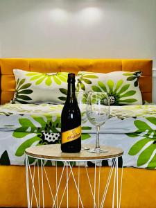 a bottle of wine and a wine glass on a table at Belveder Center Home in Ivano-Frankivsk