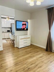 a living room with a flat screen tv on a wall at Belveder Center Home in Ivano-Frankivsk