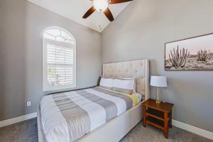 a bedroom with a bed and a ceiling fan at Palmetto Canal in Cape Coral +29 photos