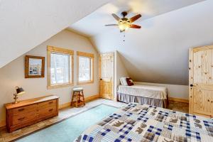 a bedroom with a bed and a ceiling fan at Wallowa Lake Wonder in Joseph