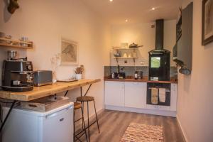 a kitchen with a counter and a stove at Borthwick Farm Cottage Annex in Gorebridge