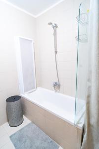 a bathroom with a shower and a bath tub at Apartment Cosmopolitan in Zadar