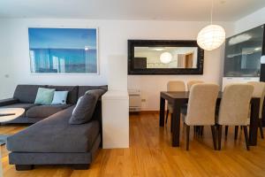 a living room with a couch and a dining room table at Apartment Cosmopolitan in Zadar
