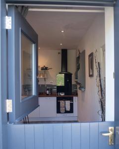 a view of a kitchen with an open window at Borthwick Farm Cottage Annex in Gorebridge