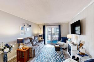 a living room with a couch and a table at Sea Cabin 117 in Myrtle Beach