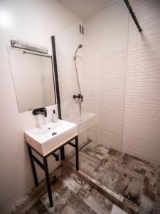 a white bathroom with a sink and a shower at Apartmán Sportovců 9 in Kutná Hora +6 photos