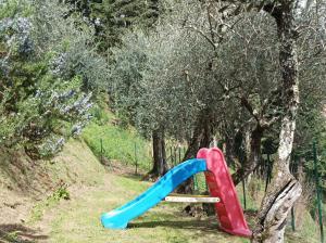 a plastic slide in a park with trees at Villa Camelia Tuscany in Pescia