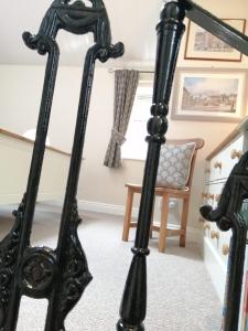 a black mirror in a room with a chair at Thirsk Stays - Bakery Cottage in Thirsk +10 photos