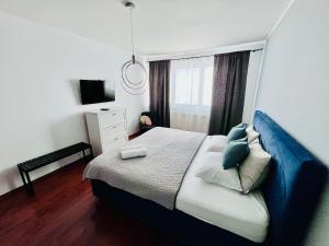 a bedroom with a bed and a television in it at City View Luxury Apartment in Banská Bystrica