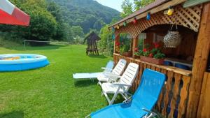 a group of chairs in a yard next to a gazebo at Casa La Măriuca in Bran