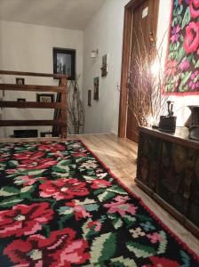 a bedroom with a bed with a colorful rug at Pensiunea La Poarta Bucovinei in Suceava