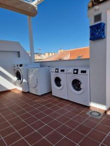 two washing machines are sitting on a patio at APARTAMENTOS ELEMAR free luggage storage in Málaga