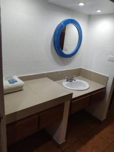 a bathroom with a sink and a mirror on the wall at Hotel POSADA DEL REY in Matamoros