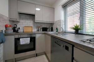 a kitchen with a sink and a stove top oven at Crewe Short Lets 6 Victoria Court, Crewe in Crewe