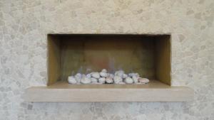 a pile of shells sitting on a shelf in a fireplace at The Old Rectory Apartment in Milton Keynes