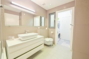 a bathroom with a sink and a toilet at Apartment Fabulous in Bat Yam