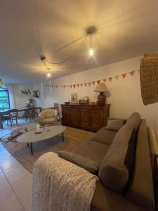 a living room with a couch and a table at Ferme St Pierre gîte autonome 2-4 personnes in Chabeuil