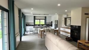 a living room with a couch and a kitchen at Casa da Falperra in Arcos de Valdevez