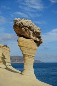 a large rock sitting on top of a beach at Tardin in Nador +4 photos