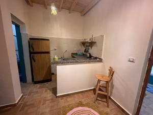a kitchen with a counter and a sink and a stool at Tota house in dahab in Dahab