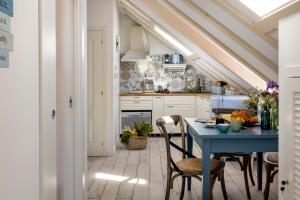 a kitchen with a blue table and chairs at Stayeva 11 in Dubrovnik