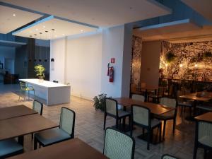 a restaurant with tables and chairs and a counter at ARTE STUDIOS in Rio de Janeiro