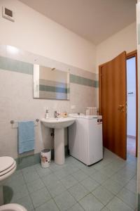 a bathroom with a sink and a toilet at Pretty house in Viareggio