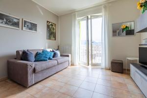 a living room with a couch and a large window at Pretty house in Viareggio
