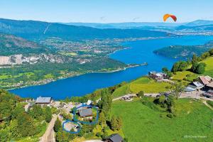 a kite flying over a lake in the countryside at STUDIO LA TOURNETTE in Montmin