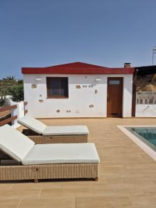a patio with lounge chairs and a house at Casa Abuela Serapia in Tuineje