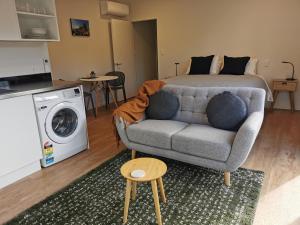 a living room with a couch and a bed at Studio 4 - NEW & Central in Hanmer Springs