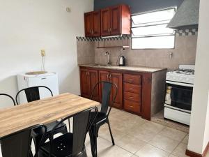 a kitchen with a table and some chairs in it at - Cambacuá VM - in Villa María
