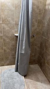 a bathroom with a shower with a gray towel at - Cambacuá VM - in Villa María
